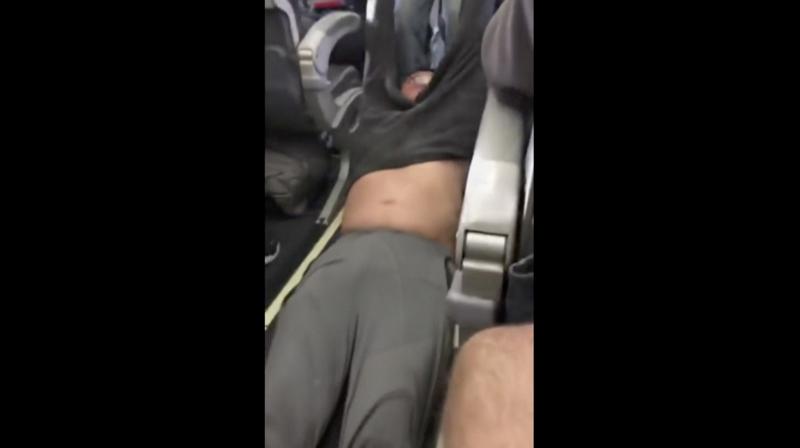 This Sunday, April 9, 2017, image made from a video provided by Audra D. Bridges shows a passenger being removed from a United Airlines flight in Chicago. (Photo: AP)