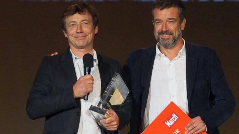 French photographer Laurent Van der Stockt (left) receives the Paris Match Visa dOr award in the news category from Paris Match deputy director Regis Le Sommier on Sept 9, 2017. (Photo: AFP)