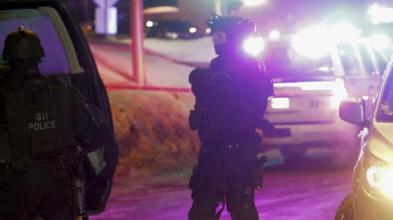 Police survey the scene after a deadly shooting at a mosque in Quebec City, Canada. (Photo: AP)