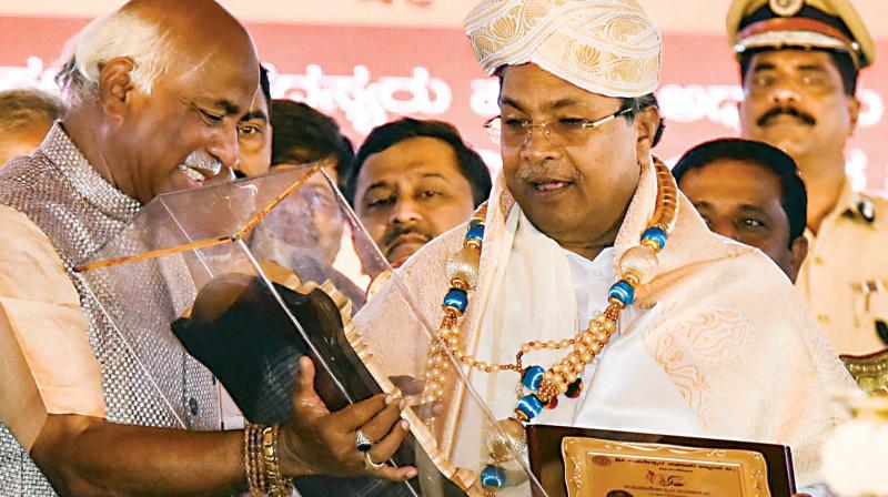 Chief Minister Siddaramaiah being honoured at a function at Navanagar in Bagalkot on Friday. (Photo: DC)