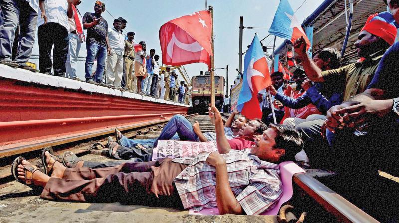 Members of Opposition parties and farmers block a track during the 48-hour state-wide rail roko protest demanding the Centres intervention in setting up of the Cauvery Management Board in the ongoing Cauvery water dispute, at Egmore Railway station in Chennai on Tuesday (Photo: AP)