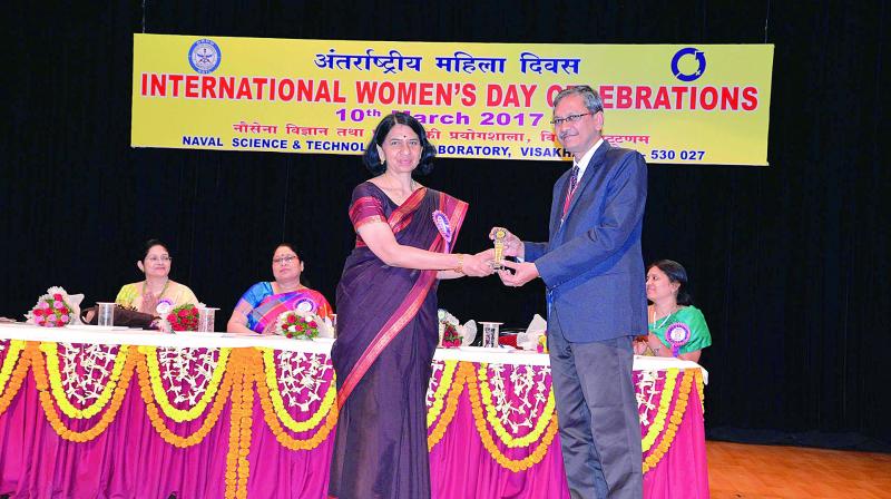 NSTL director Dr O.R. Nandagopan felicitates Chief Controller of Research and Development, System Analysis of NSTL, Dr Chitra Rajagopal, during the International Womens Day celebrations at NSTL in Visakhapatnam on Friday.