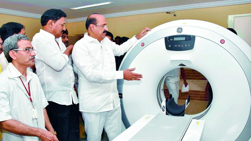 Minister for health Kamineni Srinivas and MLA Gadde Rammohan inaugurate a CT scan machine at the new government hospital in Vijayawada on Friday. (Photo: DC)