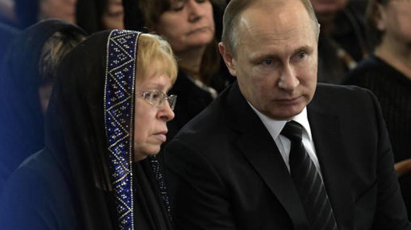 Vladimir Putin  Russian President Vladimir Putin, right, speaks to the widow of Russian Ambassador to Turkey Andrei Karlov, Marina during a farewell ceremony at the Foreign Ministry headquarters in Moscow, Russia. (Photo: AP)