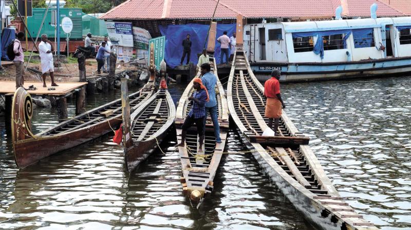 Boats get ready for the race in Kollam on Monday.