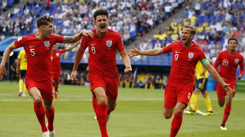 Harry Maguire celebrates with teammates after giving England the lead. (Photo: AP)