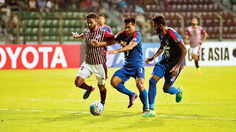 Bengaluru FCs Seiminlen Doungel and C.K. Vineeth in action against Mohun Bagan on Wednesday.