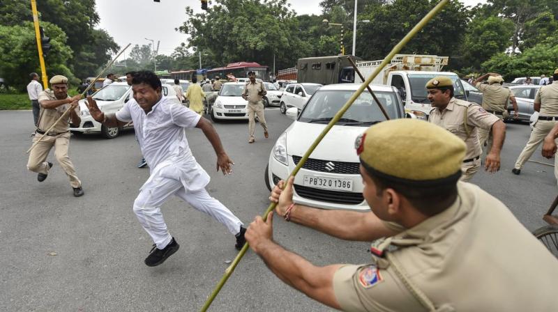 Policemen lathi-charge on members of Indian Youth Congress protesting during Bharat Bandh, against fuel price hike and depreciation of the rupee, in New Delhi. (Photo: PTI)