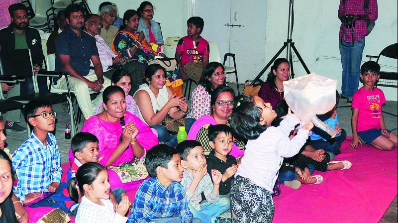 Children enjoy the play, The Bird, which was staged on Wednesday. Right, a still from the play