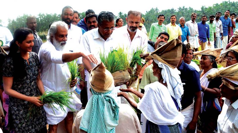 Actor Manju Warrier, singer K.J. Yesudas and Chief Minister Pinarayi Vijayan hand over paddy seedlings to  farmers marking the state-level inauguration of Haritha Keralam project at Kollayil in Thiruvananthapuram on Thursday.