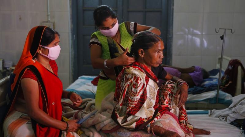 Relatives braid the hair of an Indian woman suffering from tuberculosis, admitted at the Lal Bahadur Shastri Government Hospital at Ram Nagar in Varanasi, India, Tuesday, March 13, 2018. Indian Prime Minister Narendra Modi on Tuesday launched a campaign to fast-track the Indias response to tuberculosis, which is now the worlds leading infectious killer. (Photo: AP)