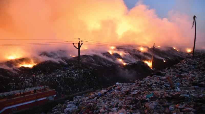 The fire engulfing the Brahmapuram waste treatment plant in Kochi on Friday. (DC)