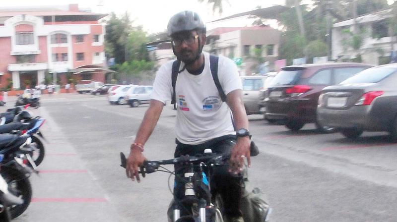 Cyclist Samrat Kousik arrives in state capital after pedalling a distance of 5,300 km from Leh on Friday.  (A.V. MUZAFAR)