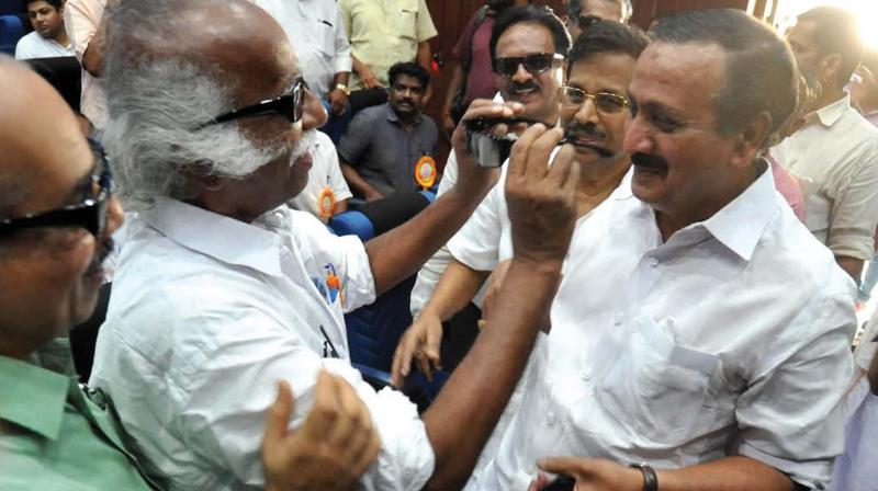 Port and museum minister Ramachandran Kadanappally helps M.K. Raghavan MP wear a 3D glass during the launch of the 3D theater at Krishna Menon Museum on Friday.  (Photo: Venugopal)