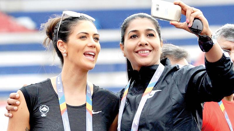 Anju Bobby George takes a selfie with TCS World 10K ambassador Stephanie Rice on Sunday. Below left: Participants take part in the Majja Run. (Photo: SHASHIDHAR. B)