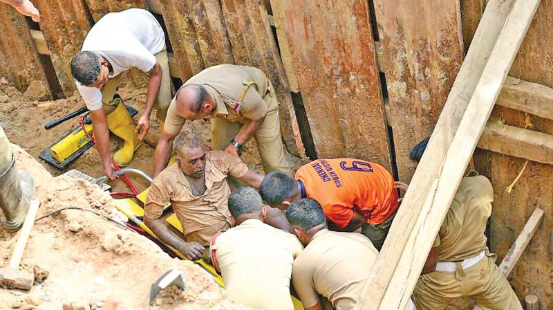 Survivor  P. Subramani being rescued out of the trench by Tamil Nadu Fire and Rescue Services Personnel in Sholinganallur. (Photo: DC)