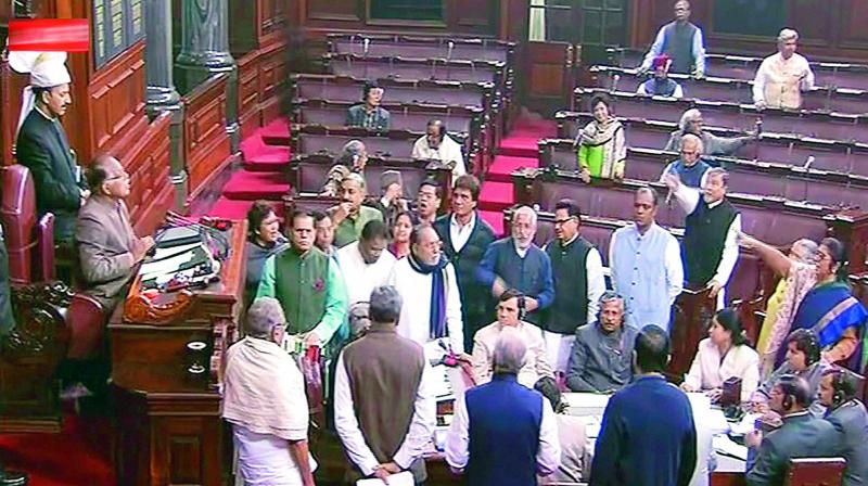 Opposition members protest in the Well of the Rajya Sabha in New Delhi on Wednesday, during the ongoing Winter Session of Parliament. (Photo: PTI)