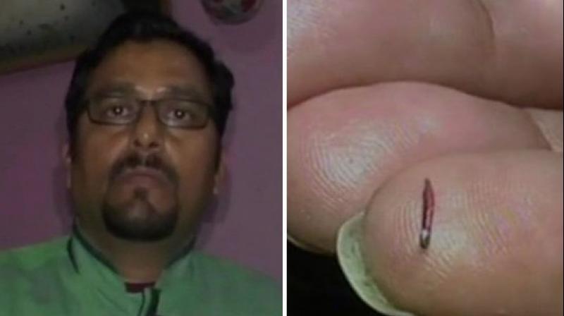 Haldwani: Artist Prakash Chandra Upadhyay holds the record of creating the worlds smallest pencil, the 5mm long and 0.5mm wide pencil is made of wood and H.B. lead. (Photo: ANI/ Twitter)
