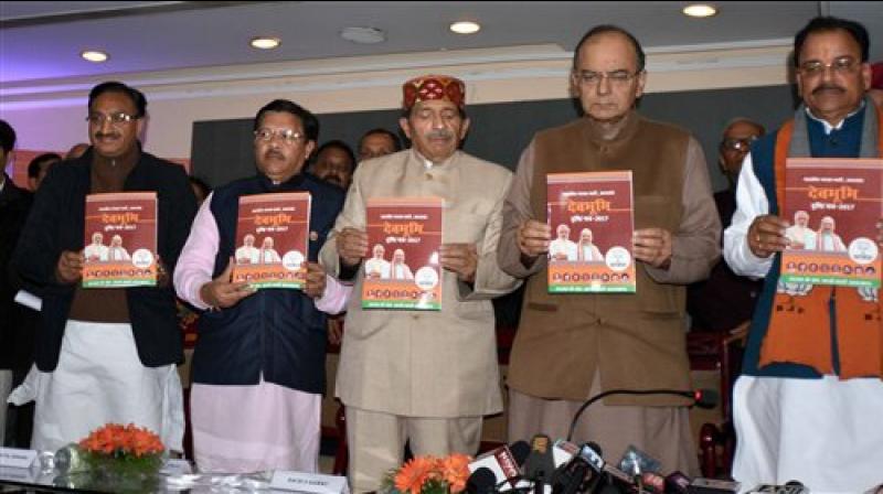 Finance Minister Arun Jaitley along with BJP Uttarakhand President Ajay Bhatt, party incharge for the state Shyam Jaju and other leaders releasing the partys vision document in Dehradun on Saturday. (Photo: PTI)