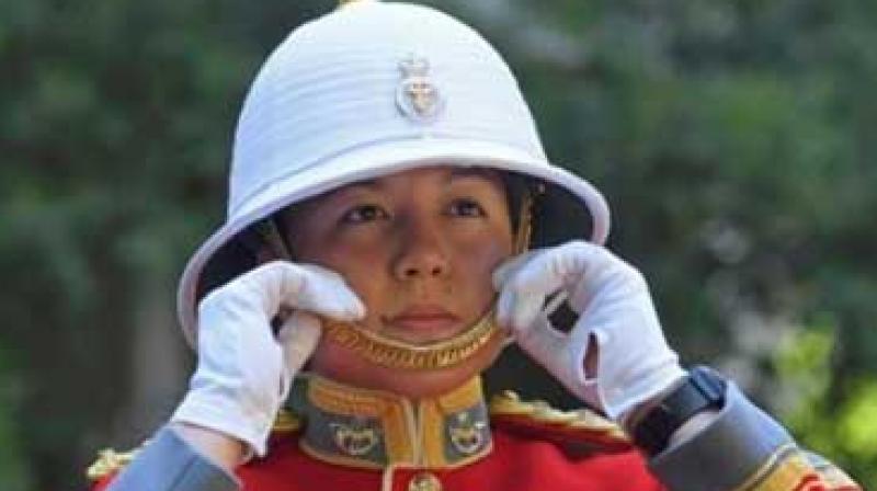 Carrying her sword and wearing a scarlet tunic and white hat, Couto marched her troops to Buckingham Palace from the nearby Wellington Barracks in the historic and colourful ceremony. (Photo: AP)