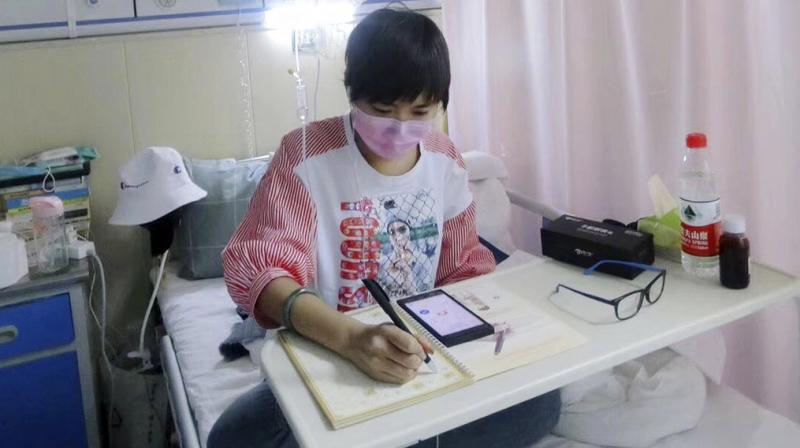 This May 2018, photo released by Su Lingmin shows her with a mask at her hospital bed in Harbin in northeastern Chinas Heilongjiang province. Diagnosed with leukemia four months ago, the 27-year-old native of the north China city of Harbin is helping give a human face to the struggle for more affordable cancer drugs in China. (Photo: AP)