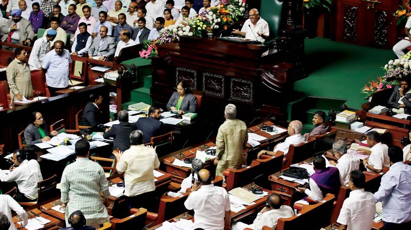 A view of the pandemonium in the state Assembly during the Budget session of the legislature at Vidhana Soudha in Bengaluru on Tuesday.