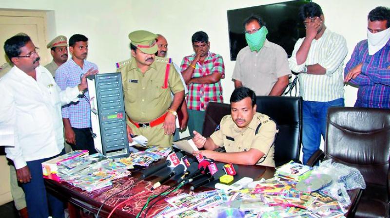 Guntur Urban SP Sarvasresth Tripathi shows the seized computer and pirated DVD/CD to mediapersons in Guntur on Monday. (Photo: DC)