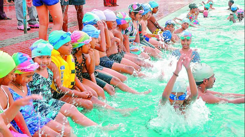 File photo of a group of children participating in a summer swimming coaching camp
