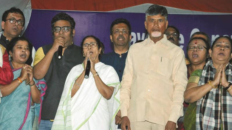 West Bengal chief minister Mamata Banerjee with TDP chief and Andhra Pradesh chief minister N. Chandrababu Naidu stand for the national anthem after announcing the end of her 46-hour-long dharna in Kolkata on Tuesday. (Photo: PTI)