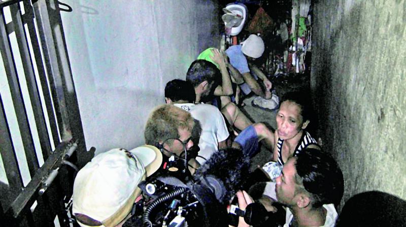 People inside a hidden room at Manila police Drug Enforcement Unit.