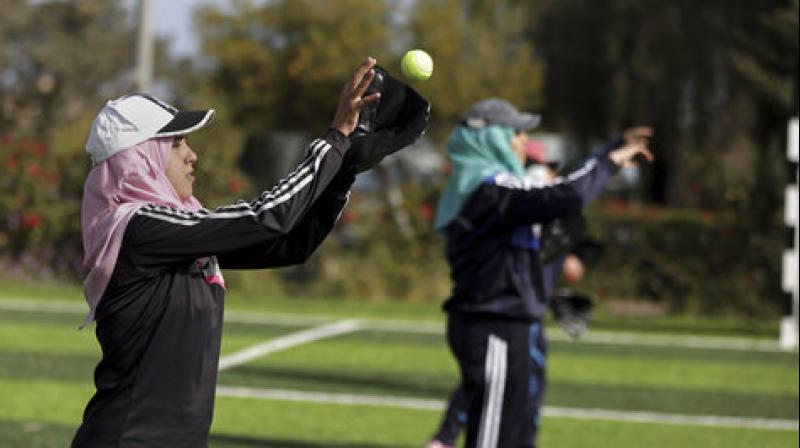 Palestinian women practice with tennis balls while training for an all womens baseball game, on a soccer field in Khan Younis, southern Gaza Strip. (Photo: AP)