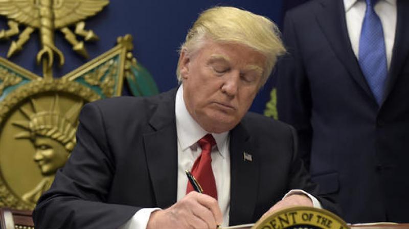 President Donald Trump signs an executive order on extreme vetting during an event at the Pentagon in Washington. (Photo: AP)
