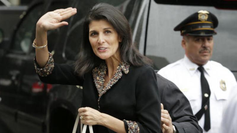The new United States Ambassador to the United Nations Nikki Haley waves to reporters as she arrives to the home of the US Mission in New York. (Photo: AP)
