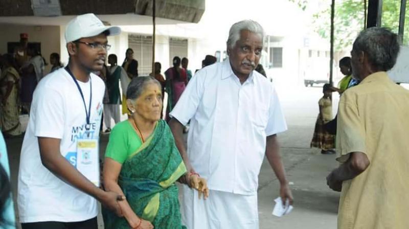 Volunteers assisting voters at a polling booth in Nellithope, Puducherry.