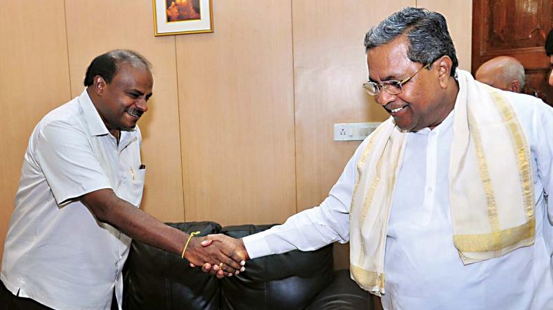 Chief Minister H.D. Kumaraswamy greets former CM Siddaramaiah at the coalitions co-ordination committee meeting in Bengaluru on Monday. (Photo: KPN)