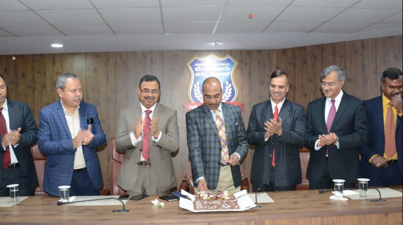Police Commissioner T. Suneel Kumar cuts a cake to mark the New Year along with additional police commissioners Bijay Kumar Singh, Seemant Kumar Singh, Alok Kumar, Harisekaran, Nanjundaswamy and Sandeep Patil in Bengaluru on Tuesday.