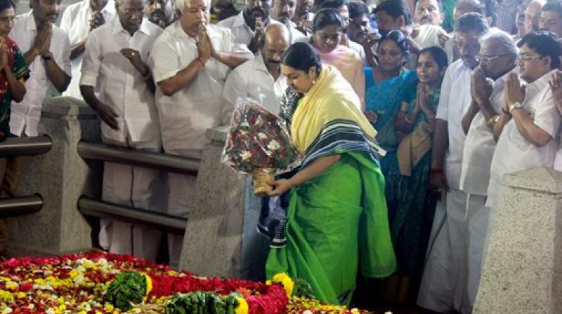 Deepa Jayakumar (C), former Tamil Nadu chief minister J Jayalalithaas niece with O Panneerselvam and MLAs pray at the grave of J Jayalalithaa in Chennai on Tuesday. (Photo: PTI)