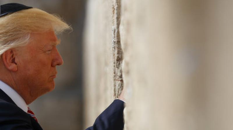 Trump paused in front of the wall and then slipped a note with a prayer between its stones, as is custom. (Photo: AP)