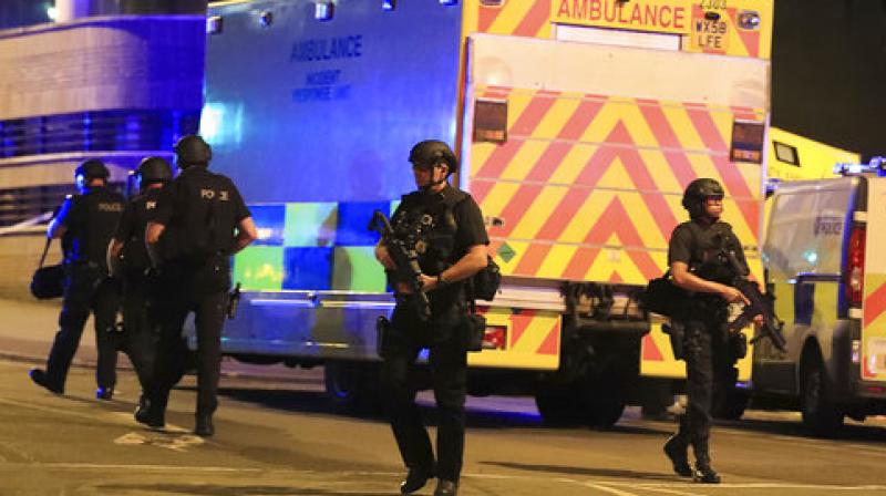 Armed police work at Manchester Arena after reports of an explosion at the venue during an Ariana Grande gig. (Photo: AP)
