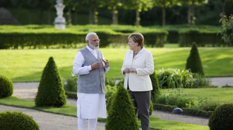 The two leaders enjoyed the sunshine with a walk in the grounds of Schloss Meseberg, an 18th century Baroque castle in the Brandenburg district of Germany which is the official state guest house of the German Chancellor. (Photo: AP)