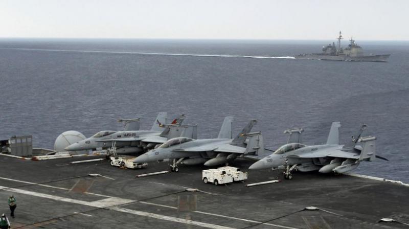 Naval warships, aircraft carriers and submarines from the U.S., India and Japan are conducting joint military exercises off Indias east coast. (Photo: AP)
