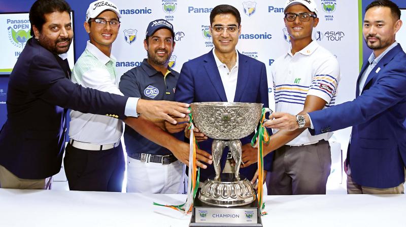 Golfers Kshitij Naveed Kaul (second from left), defending champion Shiv Kapur and Viraj Madappa pose with the Panasonic Open India trophy in New Delhi on Wednesday.