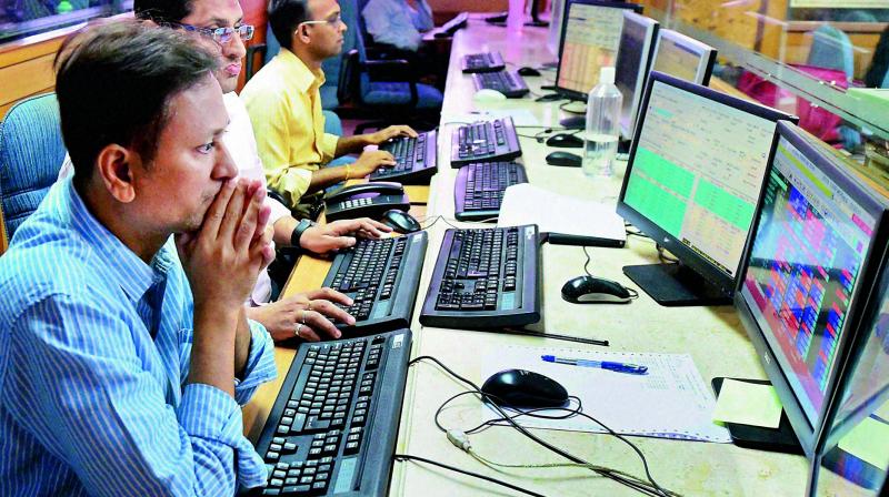 Brokers at the Bombay Stock Exchange building react as Sensex plunges in recation to the counting trends of US Presidential elections in Mumbai on Wednesday (Photo: AP)