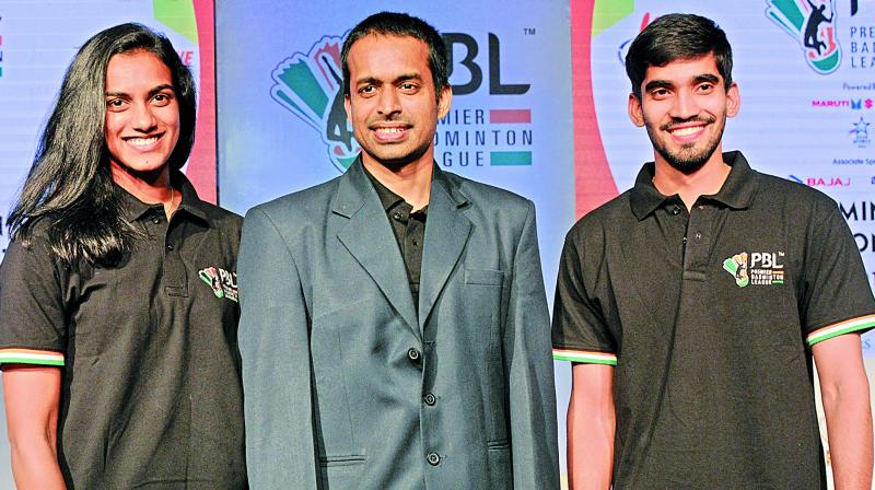 P.V. Sindhu (from left), national coach Pullela Gopichand and Kidambi Srikanth at the PBL-2 players auction in New Delhi on Wednesday. (Photo: BIPLAB Banerjee)