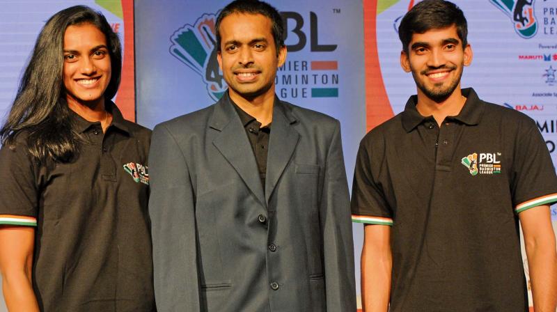 P.V. Sindhu (from left), national coach P. Gopichand and K. Srikanth at the PBL-2 players auction in New Delhi on Wednesday. (Photo: BIPLAB Banerjee)