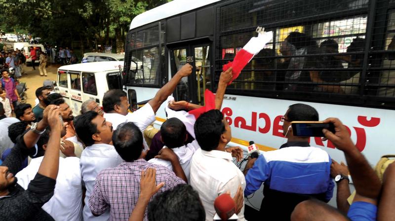 Angry mob gestures as Actor Dileep is taken for evidence collection to the Shantigiri College in Thodupuza on Wednesday. 	 By Arrangement
