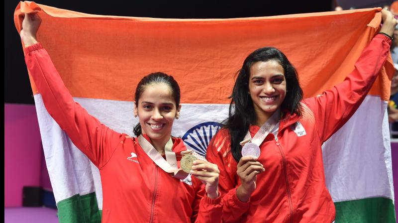 Saina Nehwal defeated her compatriot PV Sindhu by straight games in a high-octane clash to seal a 21-18, 23-21 win and clinched a gold medal in the womens singles title in the all-Indian finals of 2018 Commonwealth Games in Gold Coast, Australia on Sunday. (Photo: PTI)