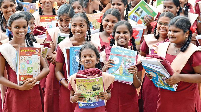 Students appear overjoyed after receiving books and uniforms on Wednesday at Egmore Presidency Higher Secondary school.