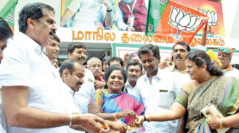 State BJP state president Tamilisai Soundararajan distributes sweets to cadres celebrating partys victory in UP polls. (Photo: DC)