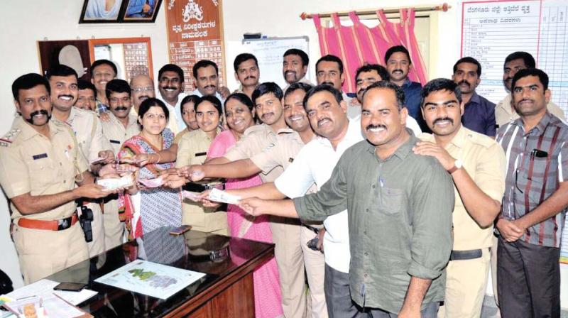 Attibele and Sarjapur police donated 75,000 to Chief Ministers Calamity Relief Fund in Bengaluru on Monday. (Image Dc)